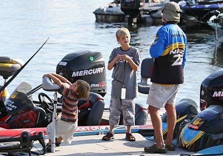 Rick Clunn's two sons played on the deck of his boat, while Clunn waits to weigh in on at the end of Day Two. 