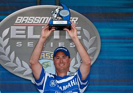 Tim Creighton hoists the trophy as the co-angler champion at the Empire Chase presented by Farmer's Insurance.