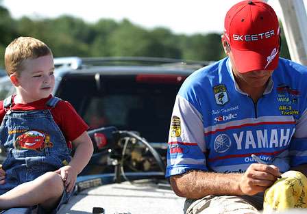 Todd Faircloth signs the cap of one of his youngest fans in Angler Alley.