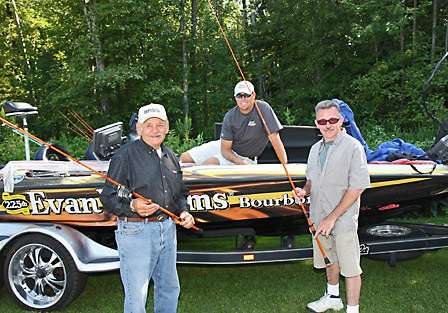 Russ Lane answers questions John Henthon and Dan Peck have about the superlight E 21 rods they picked up from Lane's boat deck. 