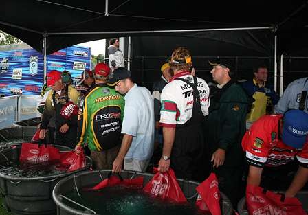 Elite Series anglers and their co-anglers wait backstage to carry their fish to the scales.