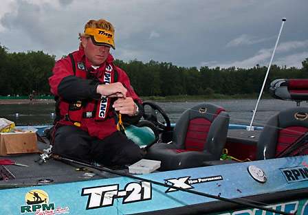 Rick Morris makes final adjustments to a crawdad imitation as he waits at the dock for his co-angler.