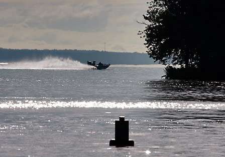 One of the competitors speeds up the lake and out of sight.
