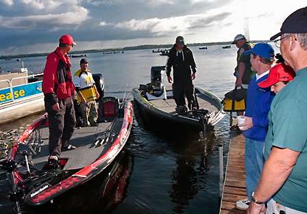 Casey Ashley picks up his co-angler as Derek Remitz eases in to the dock to pick up his co-angler.