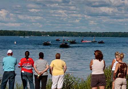 Fans line the bank at Oneida Shores Park as the first flight makes its way to the dock.
