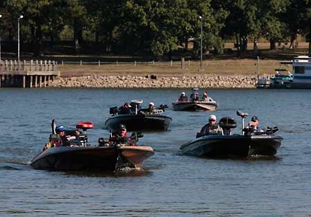 The first flight of anglers ease their way into the Paris Landing marina cove where they will trailer their boats before bagging fish and heading to the stage.