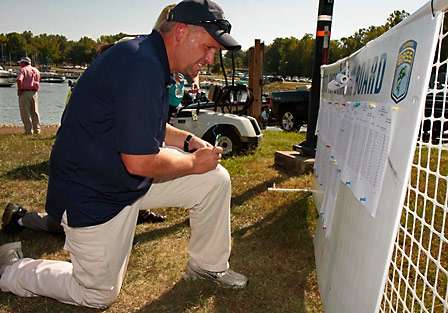 Tim Guinn checks the information board where pairings for Day Two were listed.