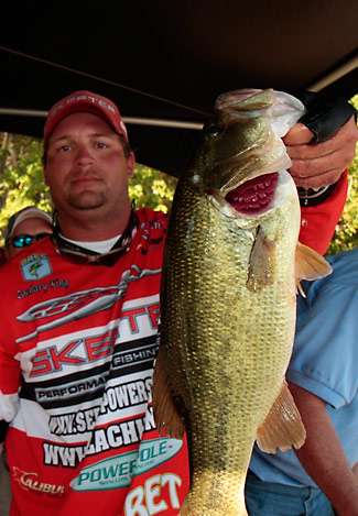 Zachary King holds up a nice largemouth just before he steps on stage to get an official weight.