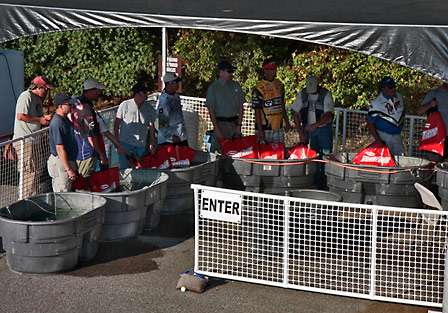 Anglers wait patiently in long lines at the tanks for their turn to get an official weight.