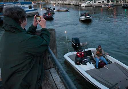 Dannie Boyd takes a photo of her nephew Brian Jackson who is fishing the Central Open as a co-angler.