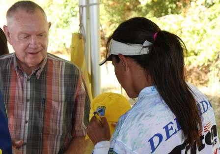 Mary Delgado signs an autograph for Ted Wagnon, one of the volunteers for the event.