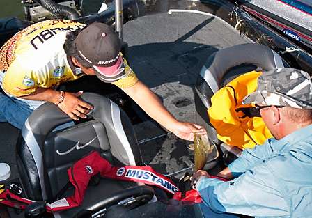 Bassmaster Elite Series pro Ben Matsubu unloads his live well as he prepares to go to the stage for an official weight.