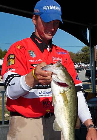 Bassmaster Elite Series pro Brian Clark holds up one of his larger bass for the Bassmaster cameras. Clark would finish Day One in fourth place with 14 pounds, 5 ounces.