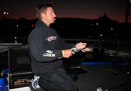 Bassmaster Elite Series pro Brian Clark makes final changes to his gear as the early morning skies turn pink.