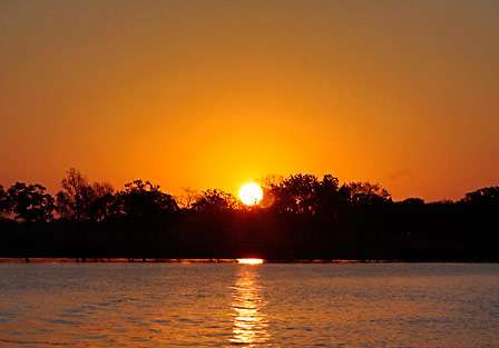 The sun rises on calm waters on the 'little glasses' portion of Lake Texoma.