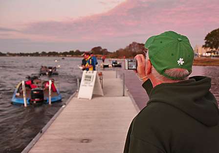 Tom Howell takes photos of the anglers as they launch from the docks at Wooten Park.