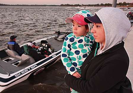 Salina Castillo and her daughter Madison watch the procession of boats as they go through the inspection line before launching onto the Harris Chain of Lakes.