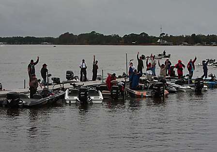 Anglers in flight number four raise their hands to signal that they need a tournament bag for their days catch.
