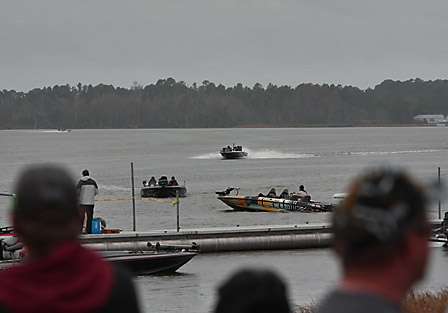 The pros and co-anglers of flight five race toward the dock to stop the clock prior to their designated weigh-in time.