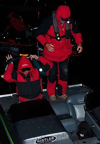 Scott Ashmore pulls on his life jacket as he and his partner head to the launch area.