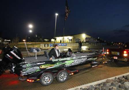 Elite Series pro Fred Roumbanis checks behind him as he rolls into the Red River before dawn Tuesday.