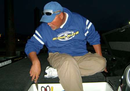 Just before dawn breaks, Matt Herren readies his equipment in preparation for the final day of practice for the 2009 Bassmaster Classic.