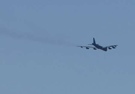 A B-52 bomber from nearby Barksdale Air Force Base, flies over the Red River during Wednesday's final practice.