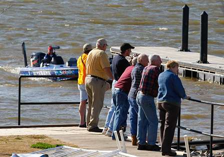 Spectators begin to gather near the boat ramp as anglers return to Red River South Marina.