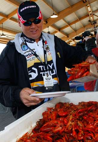 Terry Scroggins piles a heap of steaming crawfish on his plate.