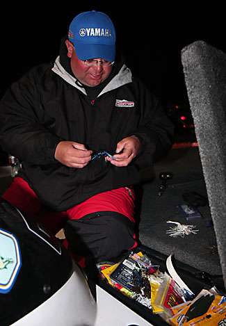 Bill Lowen makes final gear adjustments at the dock as he waits for the official 7:15 a.m. launch time.
