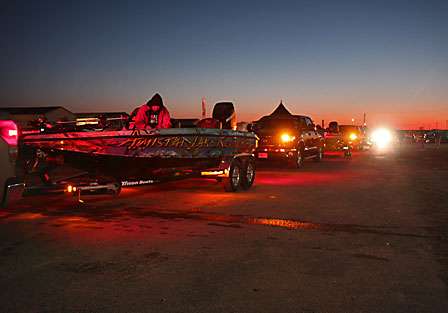 Byron Velvick sits in his boat in line as the Toyota Tundra's make their way to the ramp at the Red River Marina.