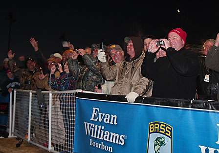 Fans line both sides of the ramp cheering each of the anglers on as they are launched into the Red River.