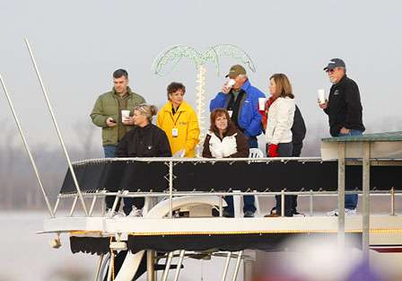 Fans enjoy the takeoff from a party barge parked at the Red River South Marina & Resort. 