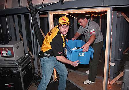 The fish are then carried out of a tunnel underneath the stage, being handed off to strategically placed personnel that help move the fish fast.