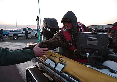 Bassmaster Elite pro Gary Klein reaches out to shake hands with his fans at the launch ramp.