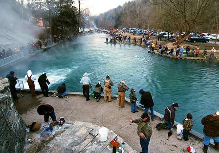 Fog and steam surround thousands of anglers fishing shoulder to shoulder at Roaring River State Park, Cassville, Mo., on opening day of trout fishing last year. 
