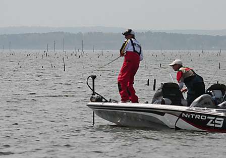 Dennis Tietje hooks into a nice bass as his co-angler John Martin heads for the net.