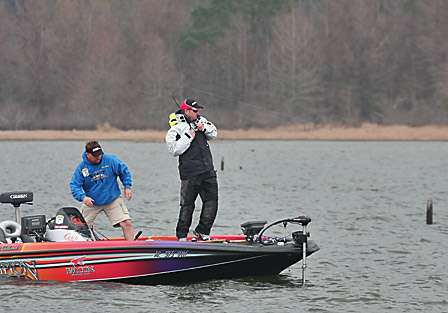 Elite Series Pro Mike McClelland hooks into a bass as his co-angler John Moon goes for the net.