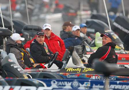 Anglers listen as BASS Tournament Director Trip Weldon announces the fog delay will continue.