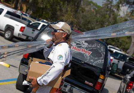 Jason Quinn makes a quick trip to his truck with a load of new fishing rods and a healthy supply of new Berkley caps. 