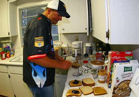 Jeremy Starks gets the peanut butter and jelly sandwiches prepared for everybody before a long day of fishing. 