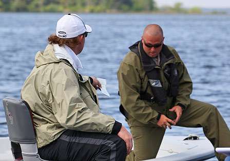 The game warden casts a suspicious eye at the fishing license presented by Pennington. 
