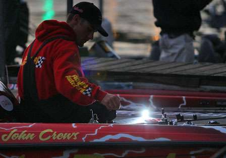 John Crews worked on his fishing tackle well before dawn on Day Three. 