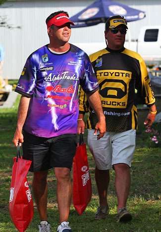 Billy Brewer and his co-angler carry their fish to the Day Three weigh-in. 