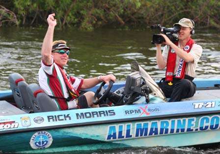 Rick Morris waves to fans as he leaves Mack's Fish Camp on Sunday, for the final day of competition.