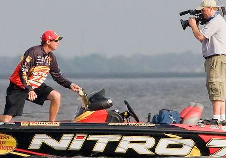 Kevin VanDam gives his ESPN cameraman, James Massey, a good look at a fish before it goes in the livewell. 