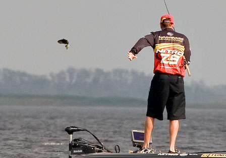 VanDam catches a short fish and immediately throws it back.