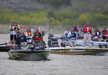 Elite Series pros and their co-anglers stand for the National Anthem just before launch time.
