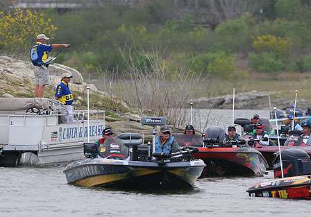 Assistant BASS Tournament Director, Chuck Harbin directs boats into position for takeoff.