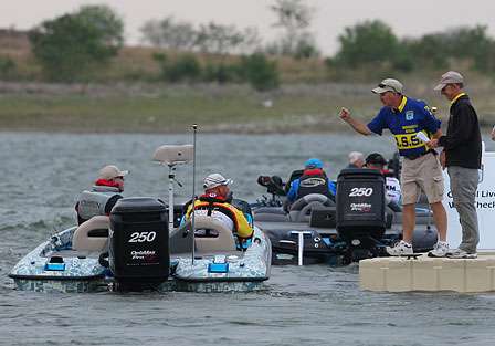 Anglers idle past the live well check as their name is called to begin Day One of the Lone Star Shootout in Falcon Lake near Zapata, Texas. 